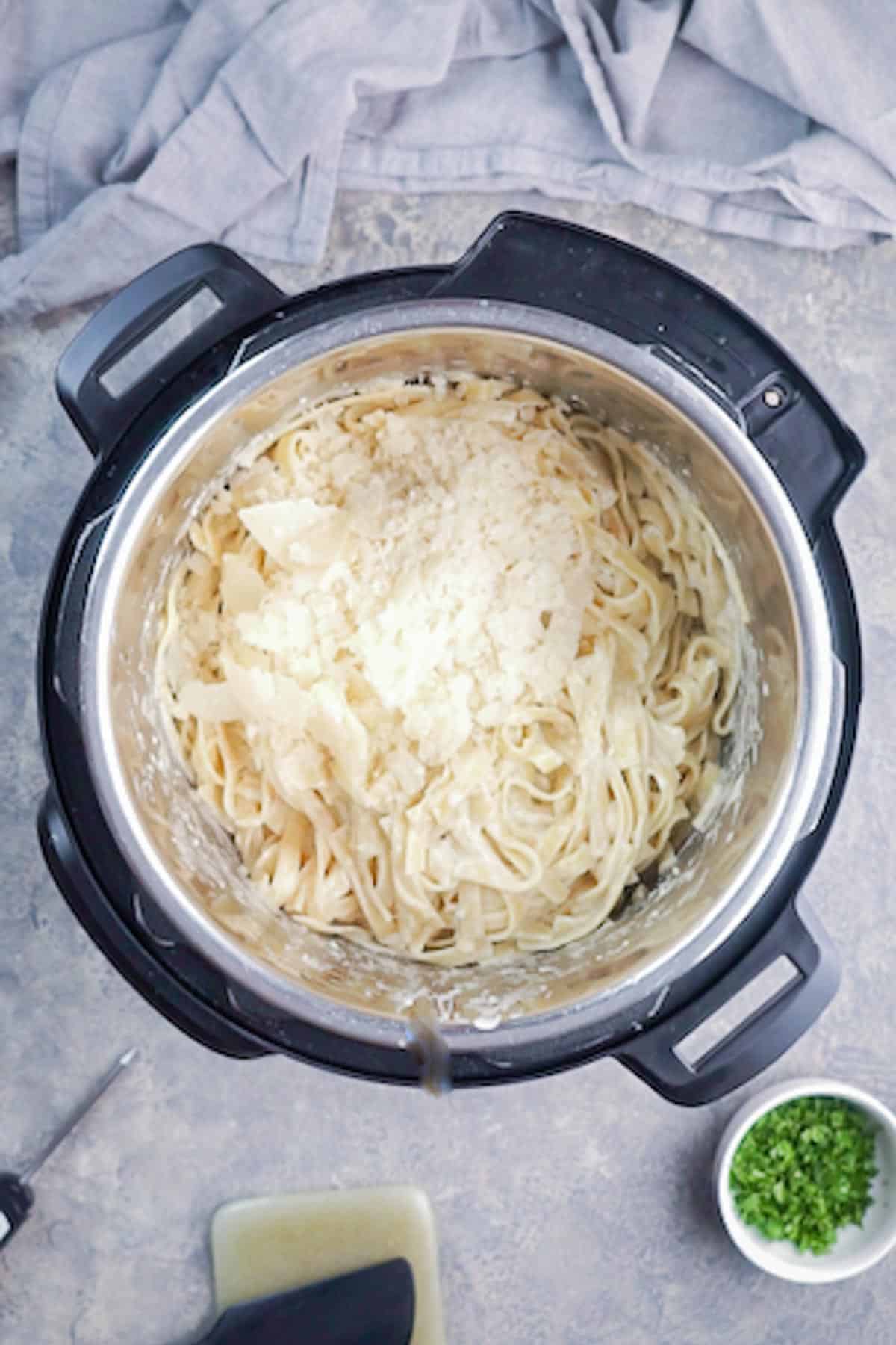 Parmesan cheese on top of chicken Alfredo in Instant Pot