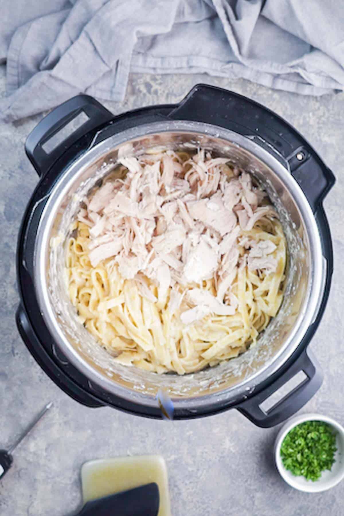 shredded chicken breast and cooked Alfredo pasta in Instant Pot