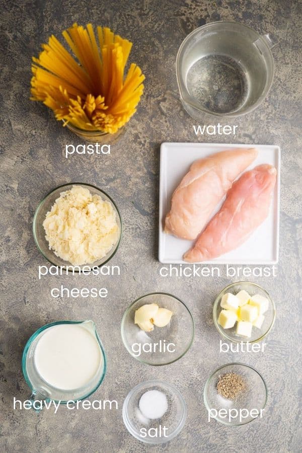 instant pot chicken alfredo ingredients in glass bowls with text overlay