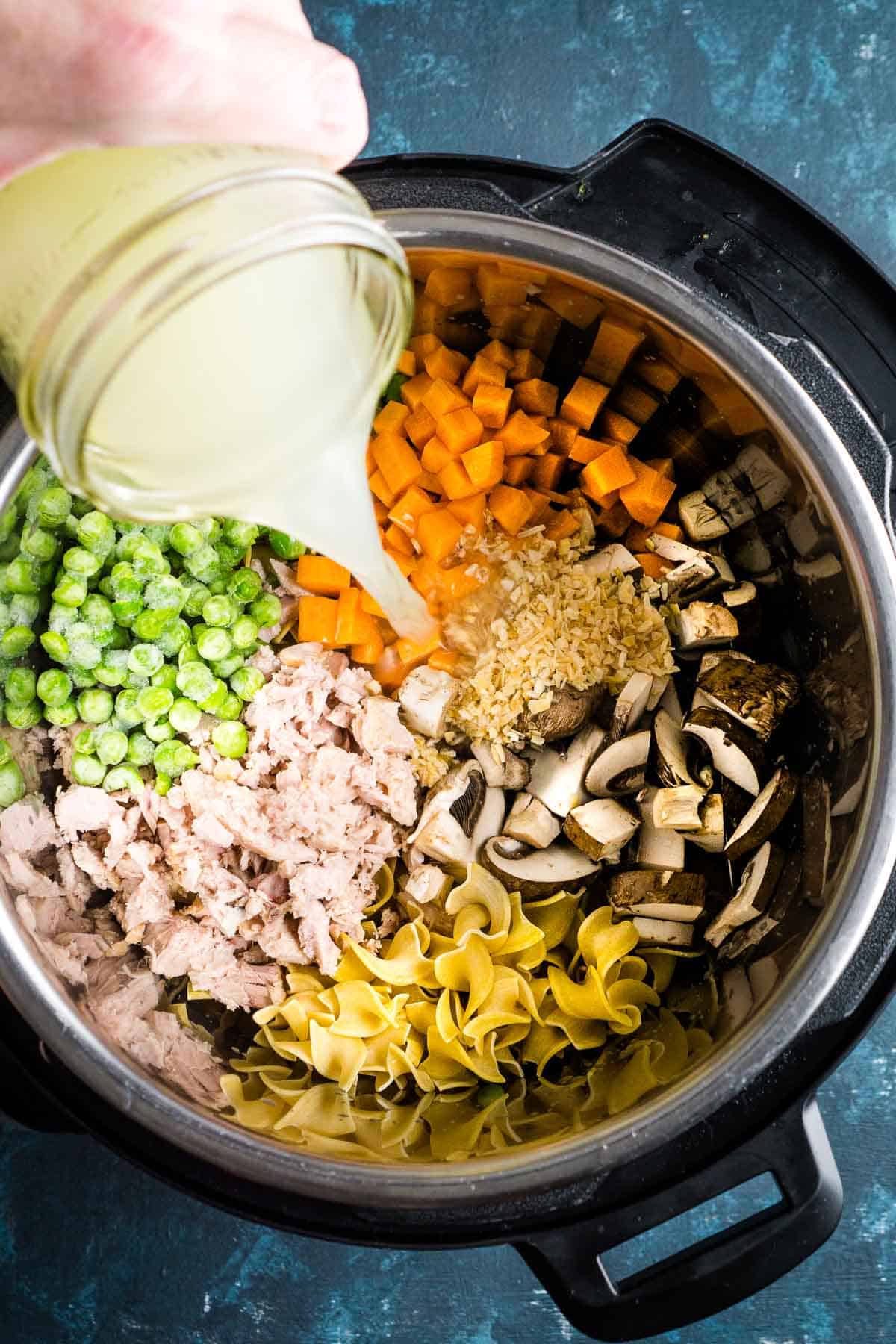 broth is added to ingredients for tuna casserole in Instant Pot