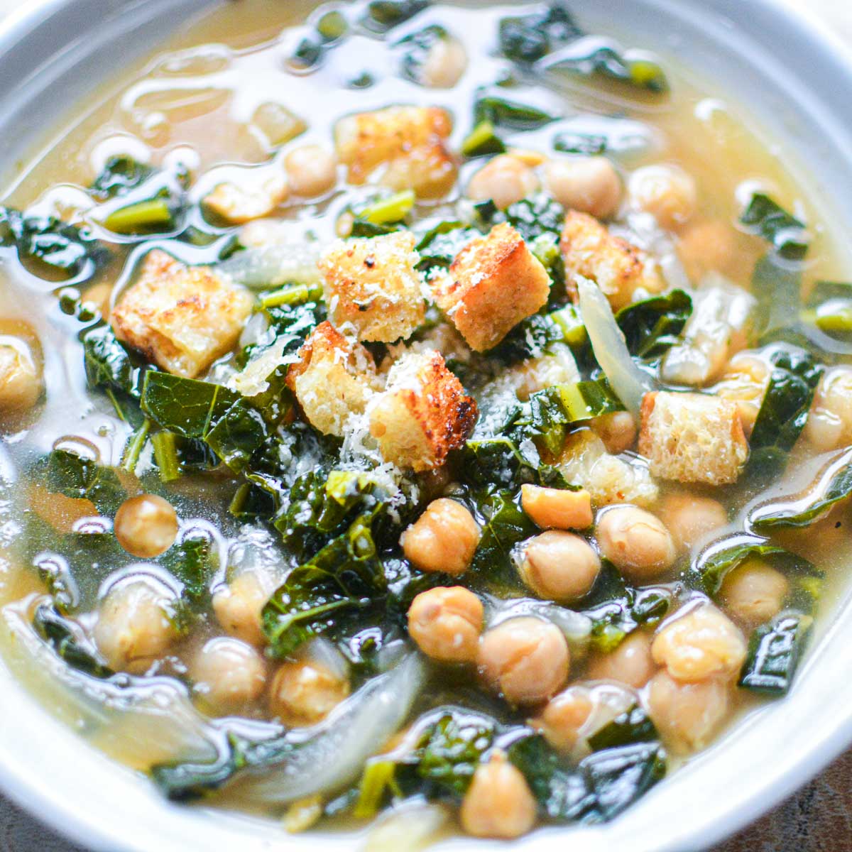 kale chickpea soup in white bowl