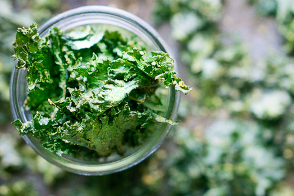 crispy kale chips stacked in glass jar