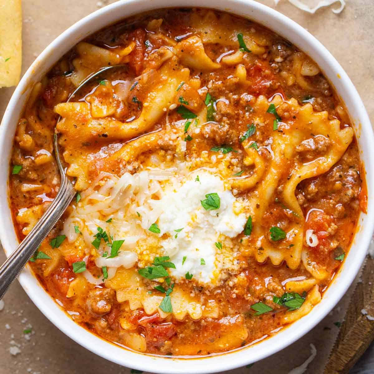 lasagna soup in white bowl with spoon