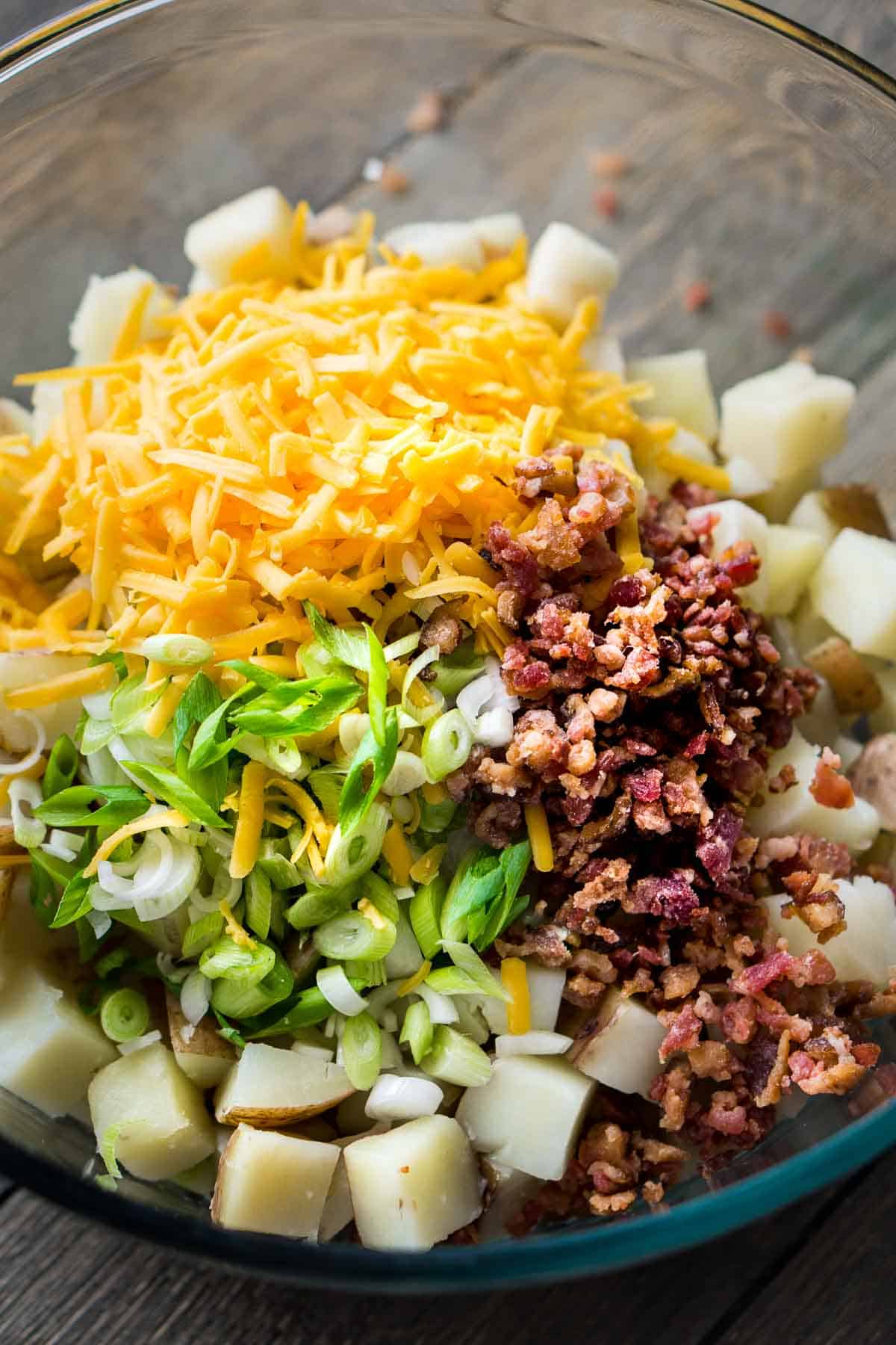 loaded potato salad ingredients in glass bowl