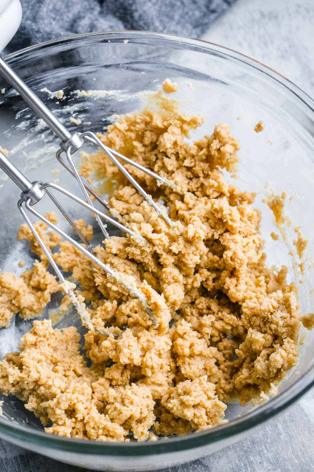 crumbled peanut butter pie mixture in glass mixing bowl