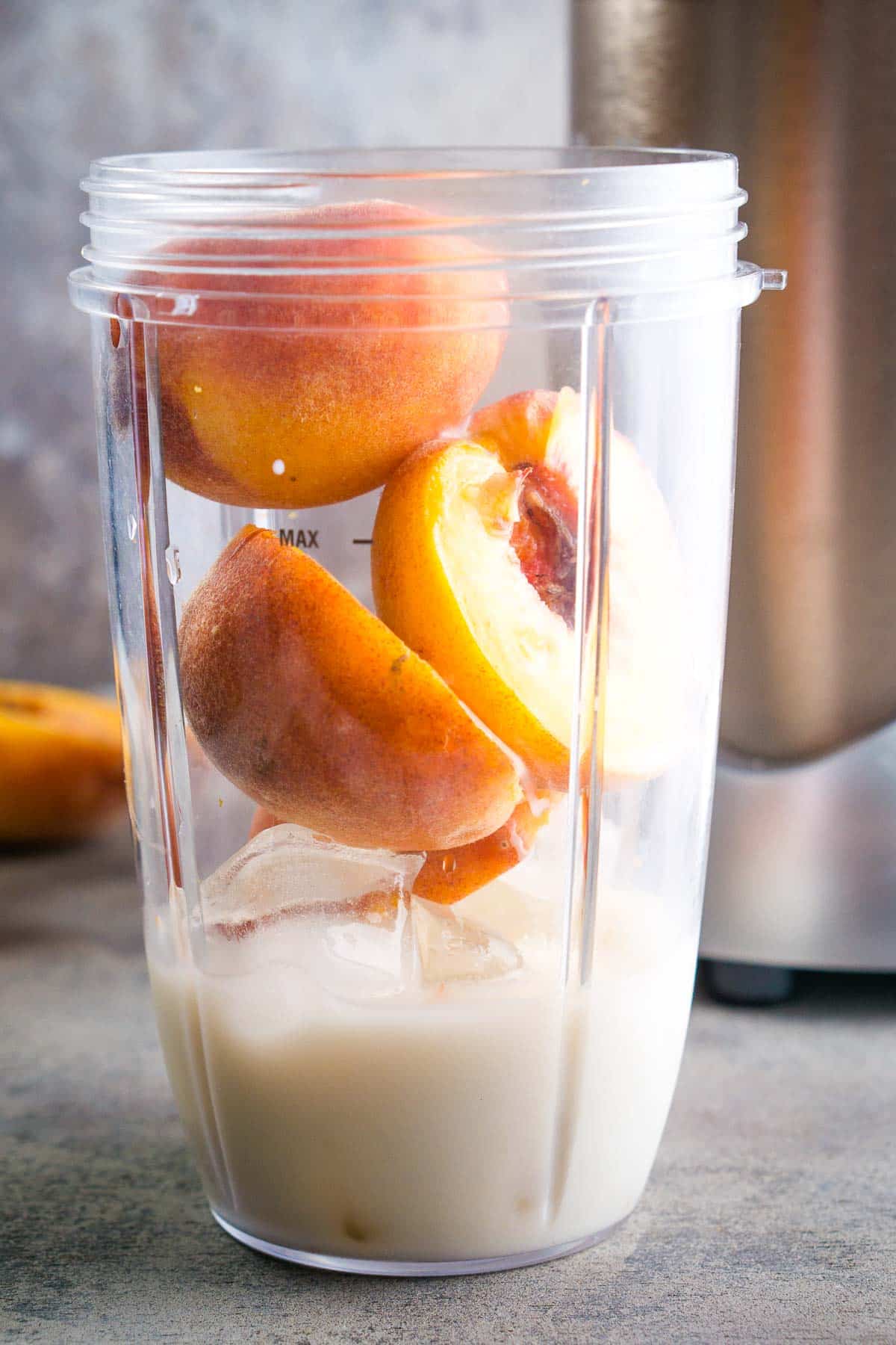 fresh peaches, ice, and milk in plastic container