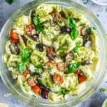 pesto tortellini pasta salad in glass serving bowl