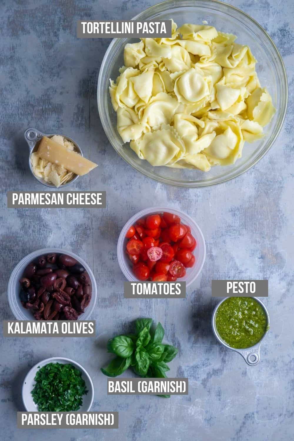 pesto tortellini pasta salad ingredients measured into bowls and ready to use