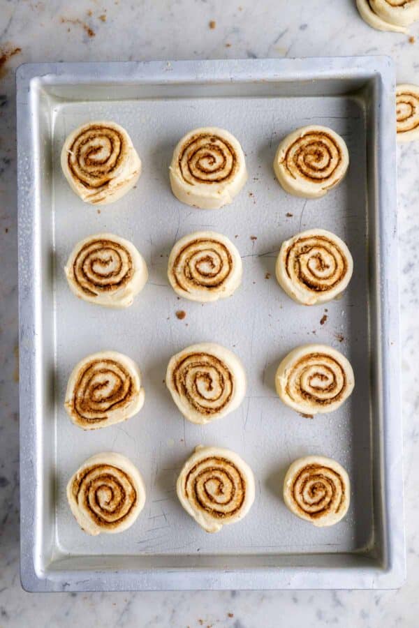 Unbaked cinnamon rolls in metal baking pan