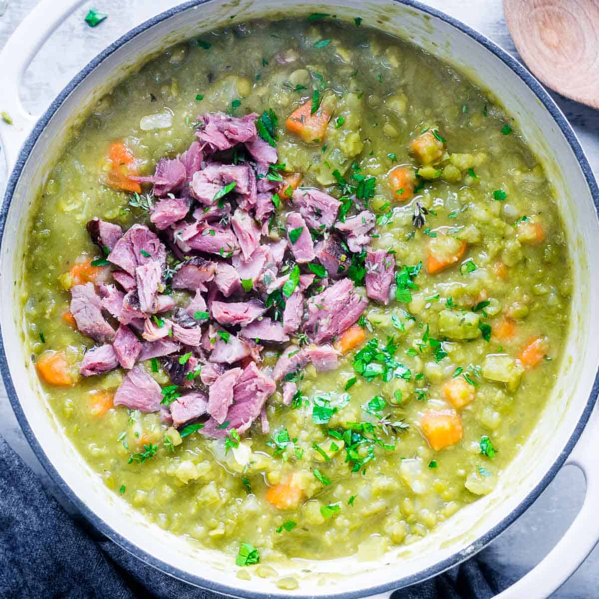split pea soup with ham in white soup pot