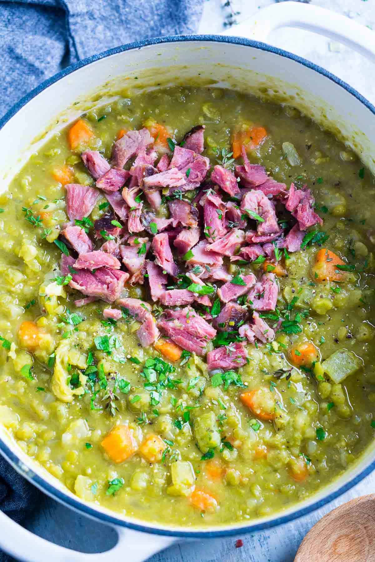 split pea soup with ham in white soup pot