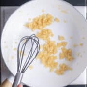 roux is whisked in white saucepan