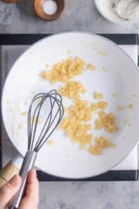 roux is whisked in white saucepan