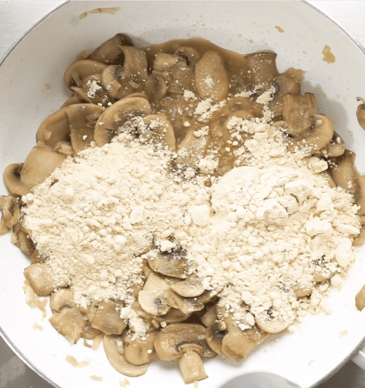 sauteed mushrooms covered with chickpea flour in white soup pot
