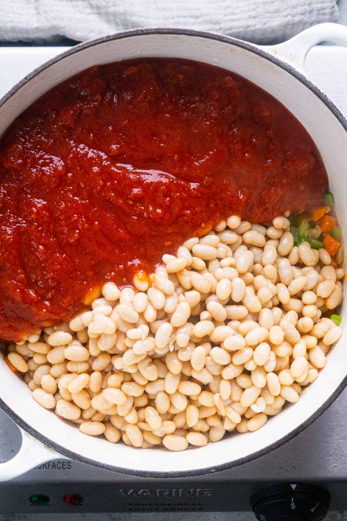white beans and tomato sauce in white dutch oven