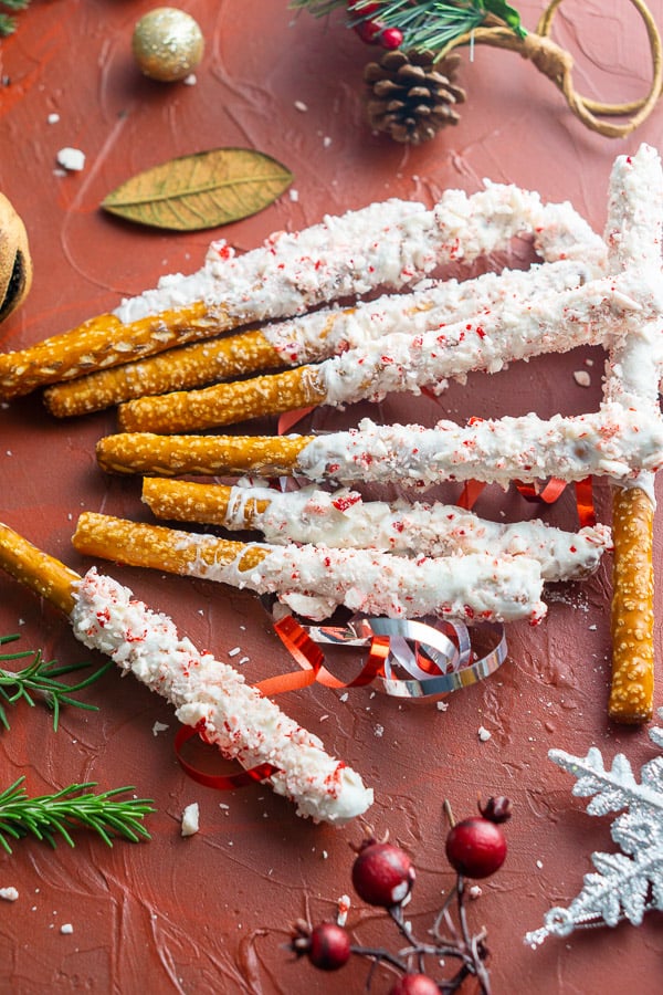 peppermint and white chocolate covered pretzels on Christmas background